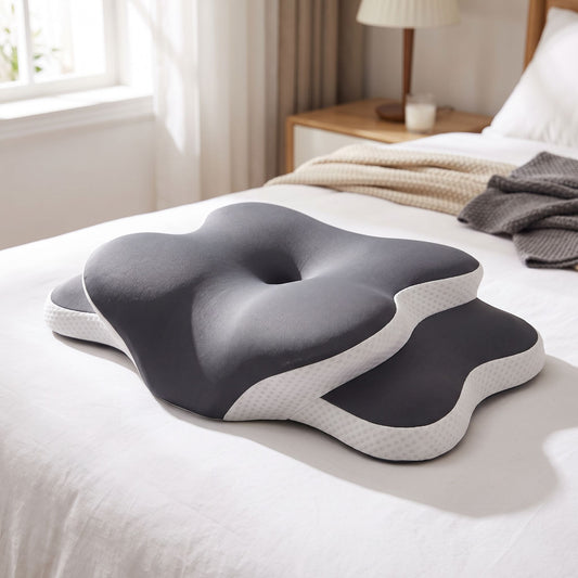 Close-up of ergonomic memory foam pillow on bed showing contour support and textured surface with cozy bedroom background.