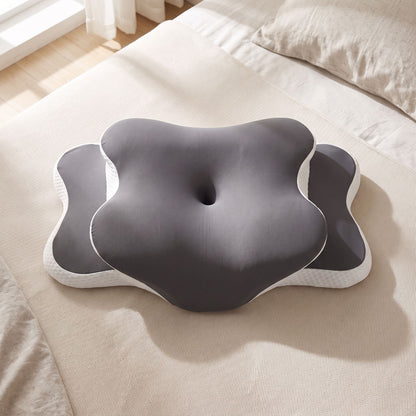 Top-down view of memory foam pillow on neutral bedspread showing ergonomic contours and foam texture with natural sunlight.